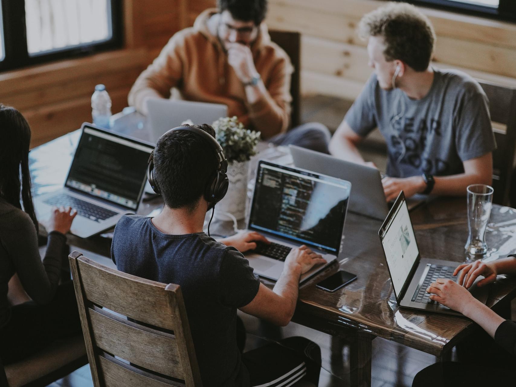 group of people using laptop computer