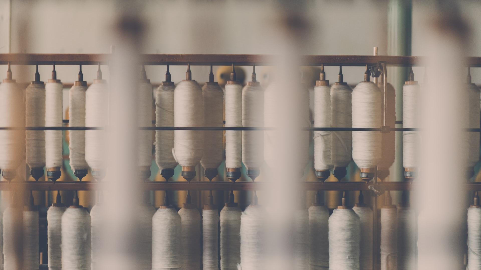 photography of white treadle on brown wooden rack