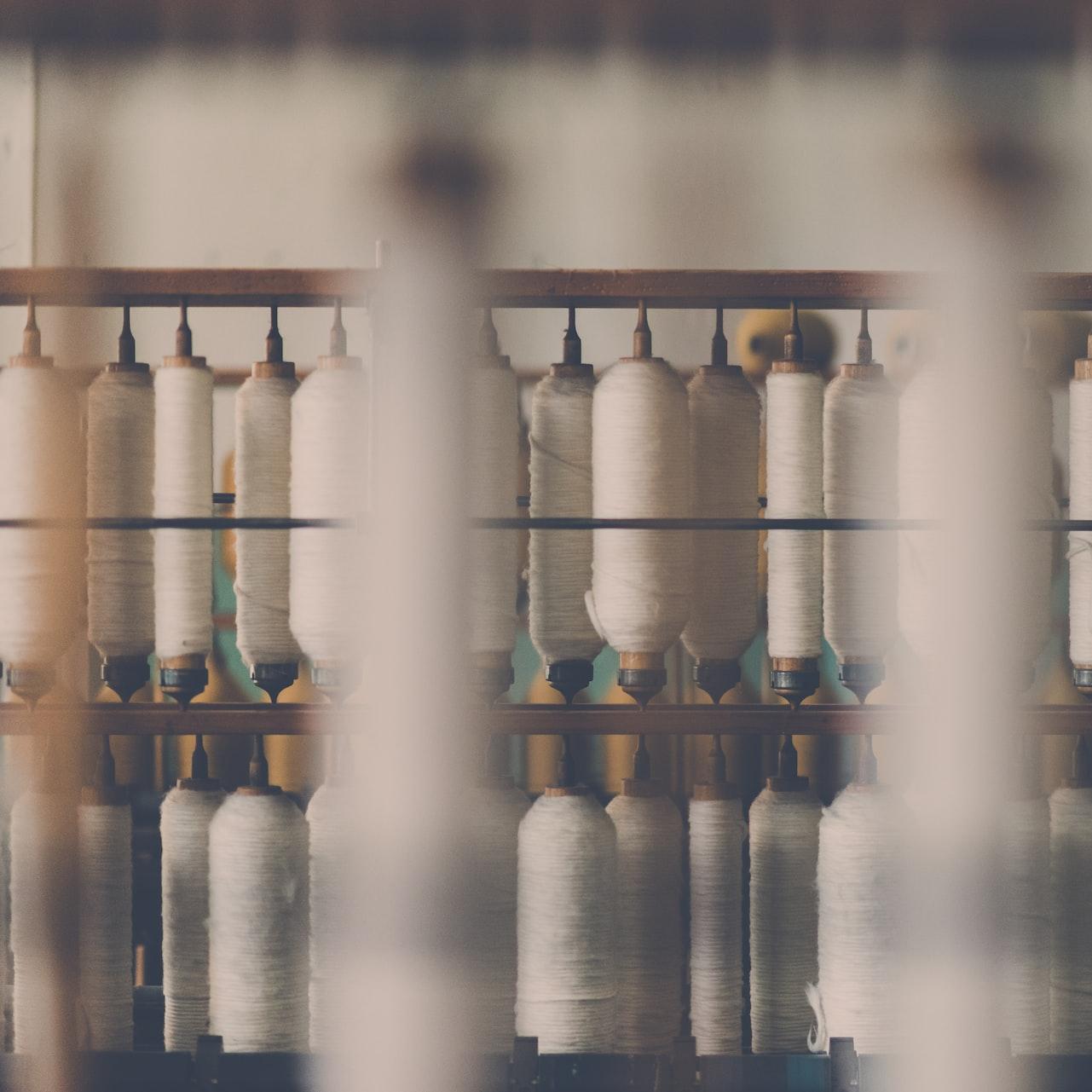 photography of white treadle on brown wooden rack