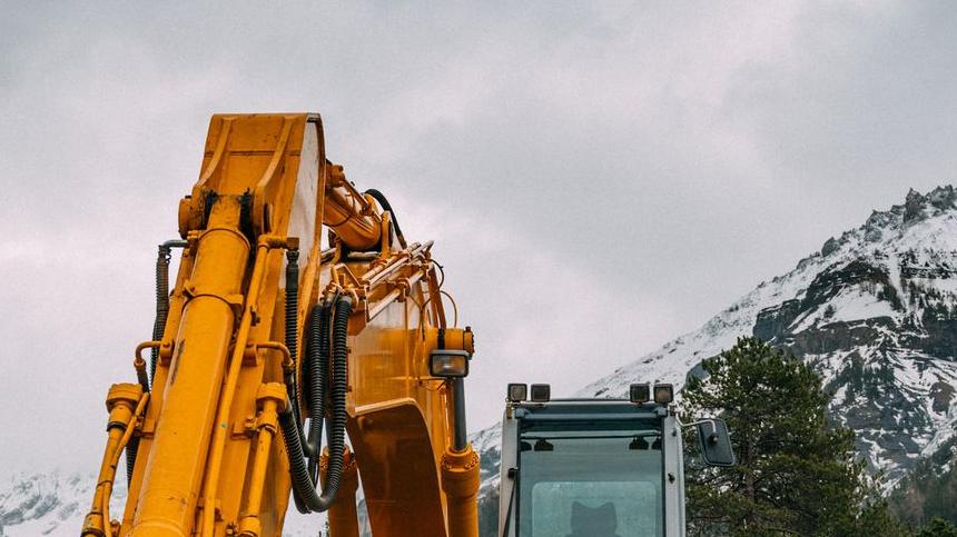 yellow and black heavy equipment on rocky ground