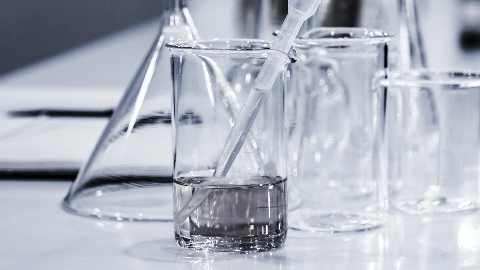 three clear beakers placed on tabletop